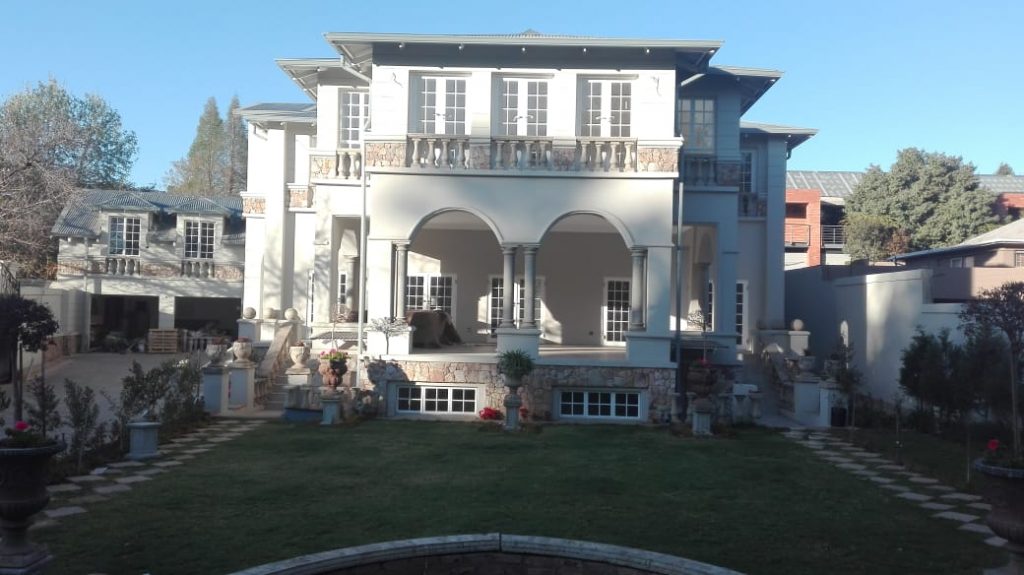Beautiful home with stone wall with stone works by newlands building projects in Forest Town, Johannesburg